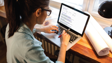 Female teen working on computer