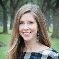 Headshot of Executive Director Laura Chrisco - Smiling brunette outdoors