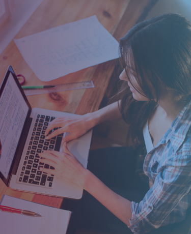 Woman typing casually at laptop in personal home