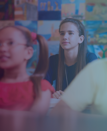 Classroom of students with focus on attentive young girl