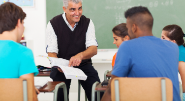 Male teacher with students in classroom