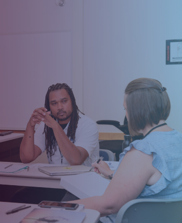 3 people at a table having a conversation